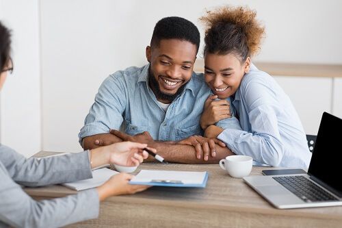 Couple signing adoption papers